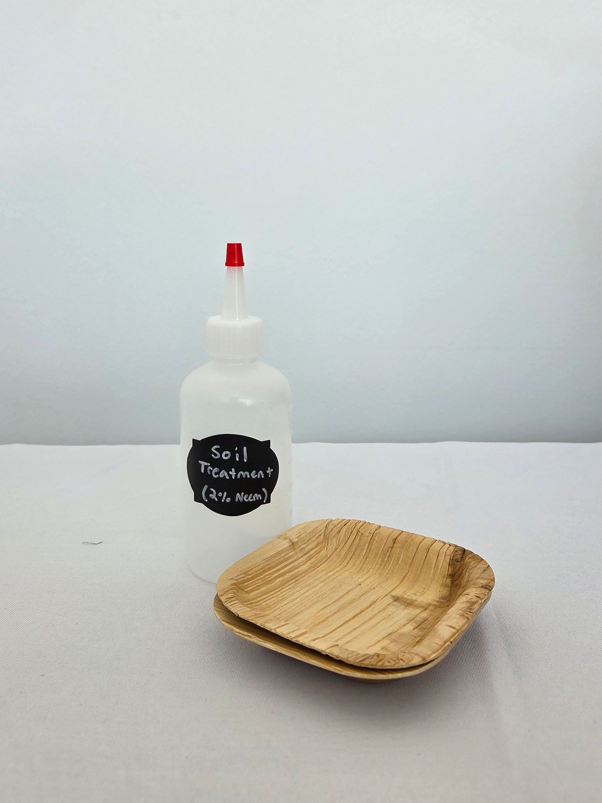 One soil drench bottle with two bamboo bowls