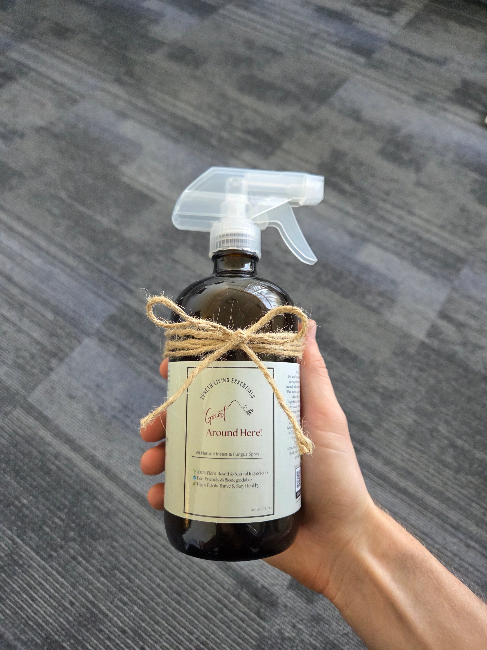 16oz brown amber glass bottle with clear plastic spray topper. "Gnat around here" plant care spray non-toxic topical treatment for indoor plants